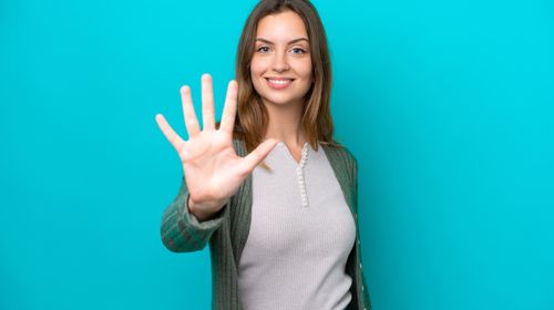young-caucasian-woman-isolated-blue-background-counting-five-with-fingers (1)-min